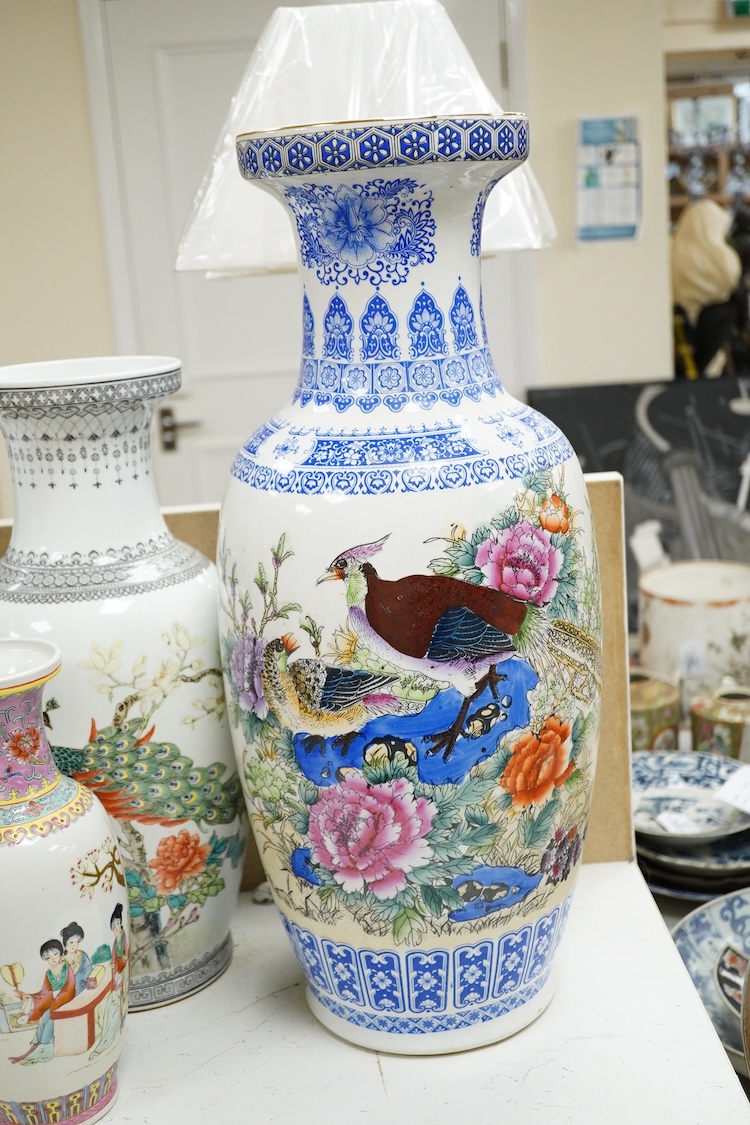 A large pair of Chinese polychrome vases, 60cm high, a pair of famille rose vases, a blue and white brushpot and two other vases (7).